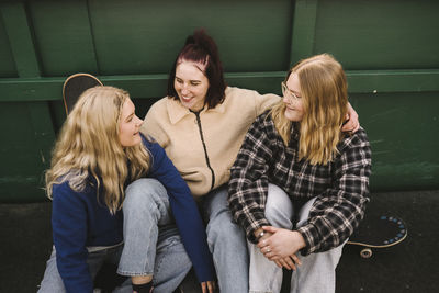 Smiling teenage girls with skateboards