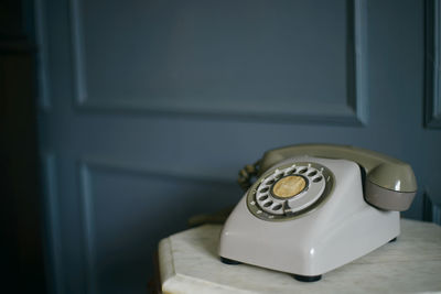 Close-up of telephone booth on table at home