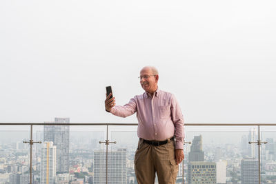 Senior man doing video call on smart phone