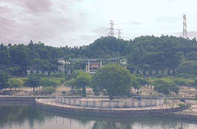 Scenic view of river by trees against sky