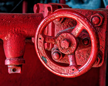 Close-up of red machine valve in factory