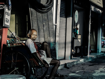 People sitting on chair in city