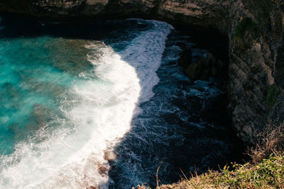 High angle view of water flowing through rocks