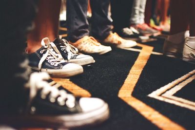 Low section of people standing on carpet