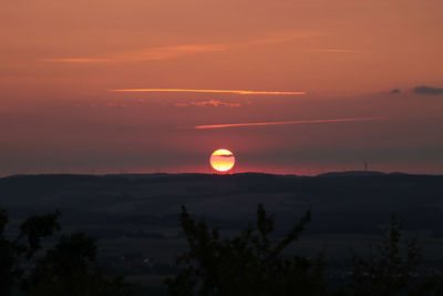 Scenic view of silhouette landscape against romantic sky at sunset