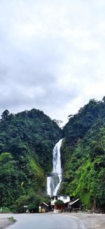 Scenic view of waterfall against sky