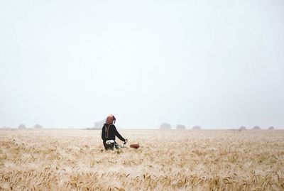 Man on field against clear sky