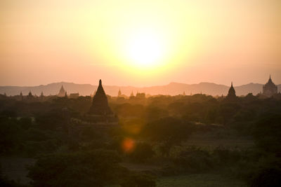 Temples against clear sky during sunset