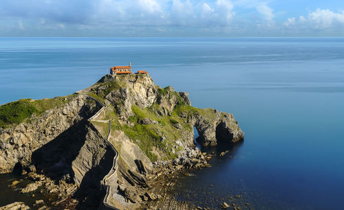 Scenic view of rock formation in sea against sky