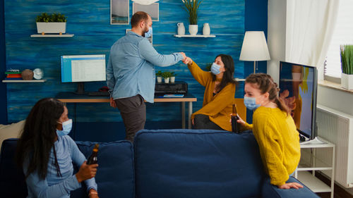 Rear view of people standing on table