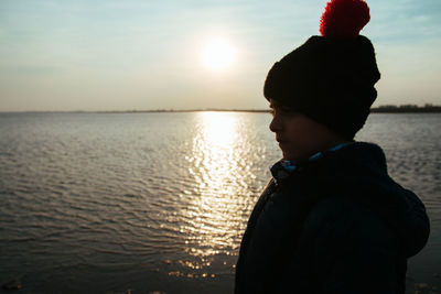 Child near the sea wearing winter clothing