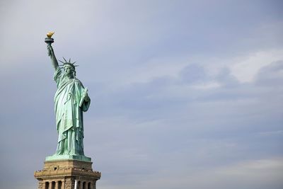 Statue of liberty against cloudy sky