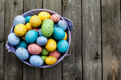 Close-up of multi colored eggs on wooden table