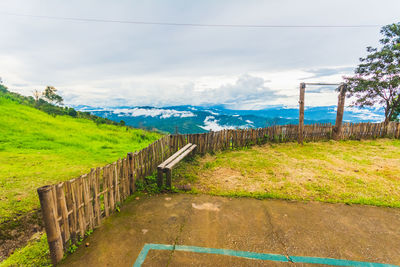 Fence on field against sky