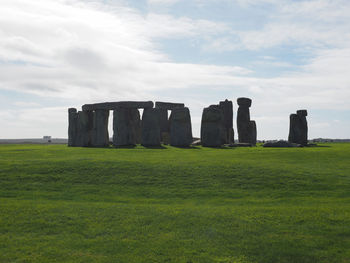 Built structure on field against sky