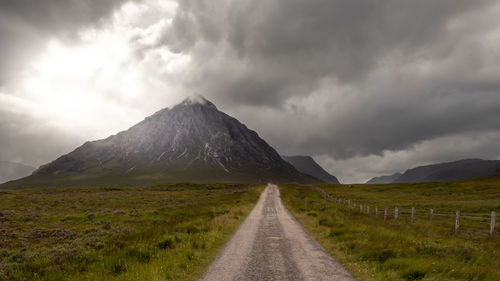 Road amidst land against sky