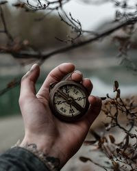 Close-up of hand holding navigational compass