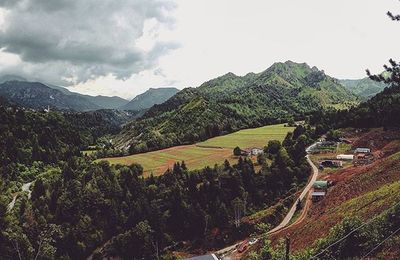 Scenic view of mountains against cloudy sky