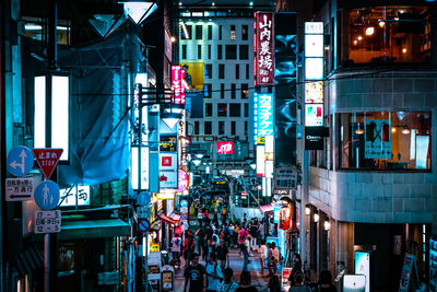 Illuminated city street and buildings at night