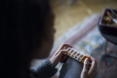 Young woman holding pill box