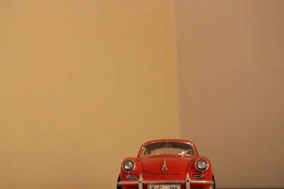 Close-up of toy car against wall