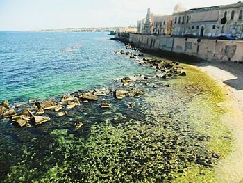 View of built structure by sea