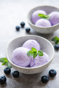 Homemade blueberry ice cream with fresh blueberries. sweet berry summer dessert. concrete background