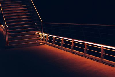 Illuminated steps against clear sky at night