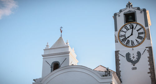 Low angle view of clock tower against sky