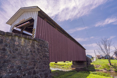 Low angle view of old abandoned building against sky