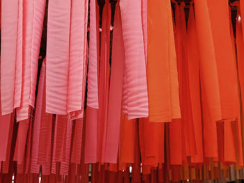 Full frame background of orange and pink hanging decorative fabric