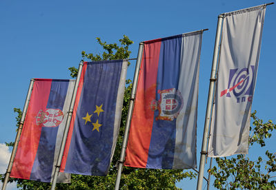 Low angle view of clothes drying against blue sky