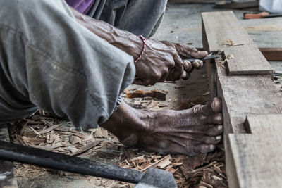 Low section of carpenter with wood working outdoors