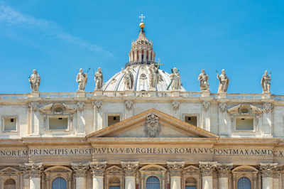 Low angle view of historic building against blue sky