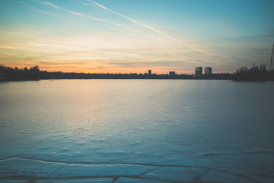 Scenic view of snow covered landscape against sky during sunset