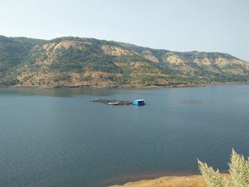 Scenic view of sea and mountains against sky