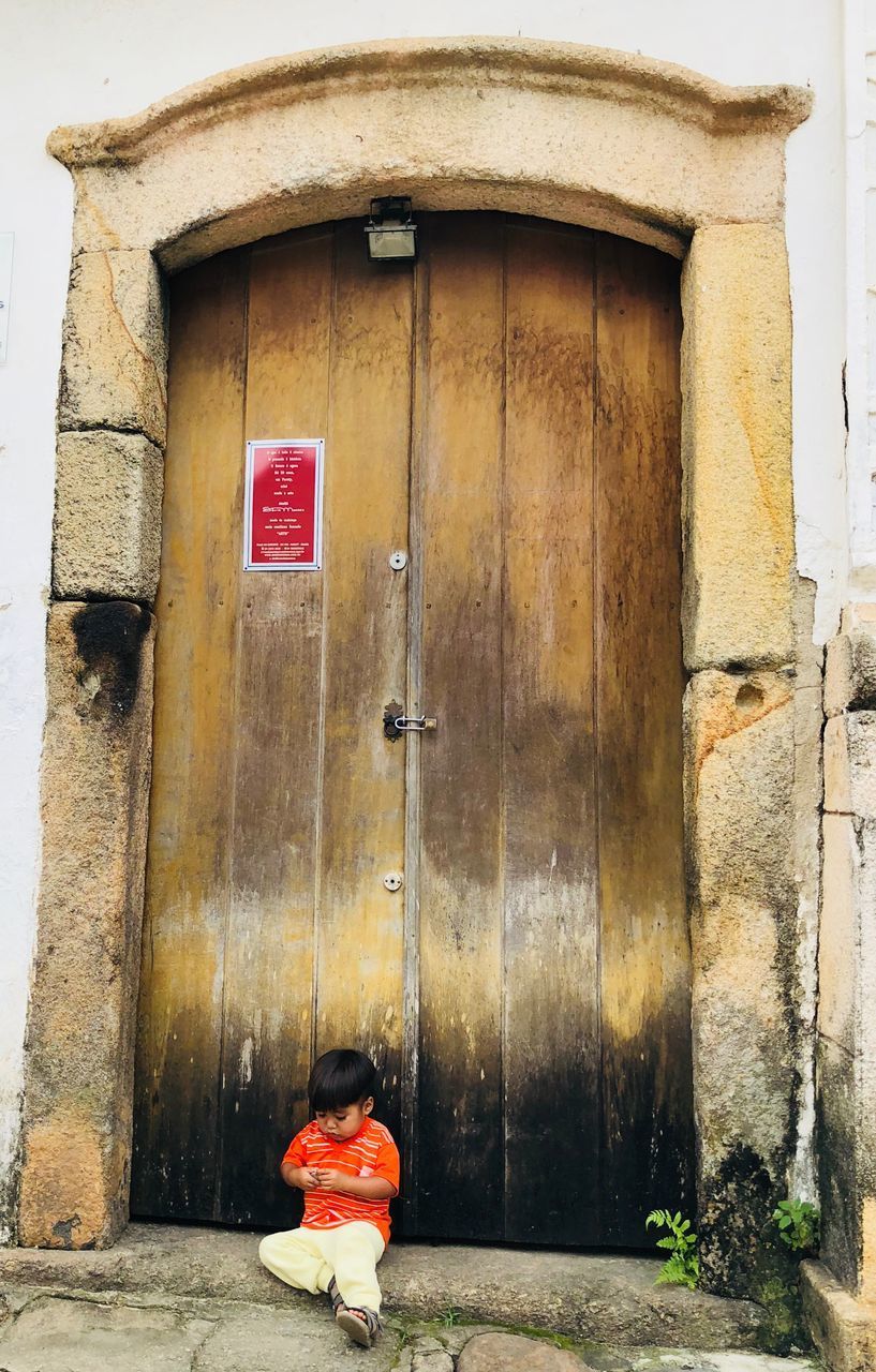 VIEW OF RED DOOR ON BUILDING EXTERIOR