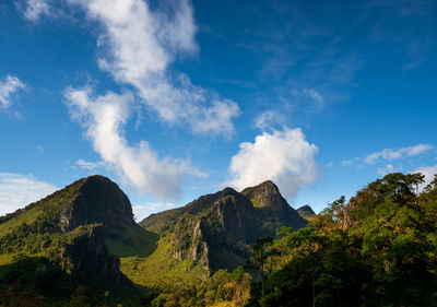 Low angle view of mountains against blue sky