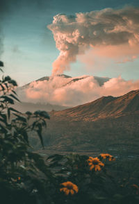 Scenic view of volcanic mountain against sky during sunset