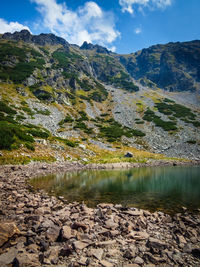 Scenic view of lake and mountains against sky