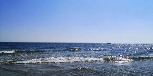 Scenic view of sea against clear blue sky