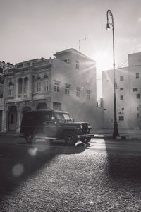 Street amidst buildings in city against sky