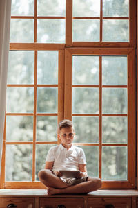 Full length of man sitting on table