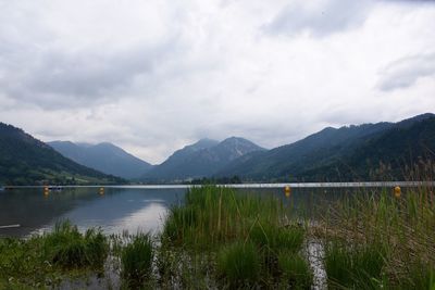 Scenic view of lake and mountains against sky