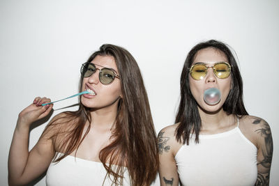 Friends blowing bubble gums