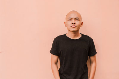 Full length of man standing against wall