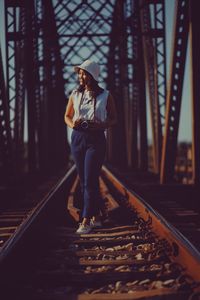 Full length of woman walking on railroad track