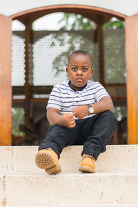 Portrait of boy sitting outdoors