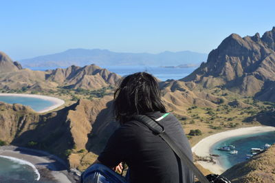 Rear view of man looking at mountains