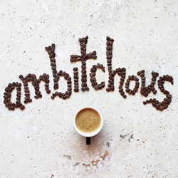 Directly above shot of word  art typography text made from coffee beans 